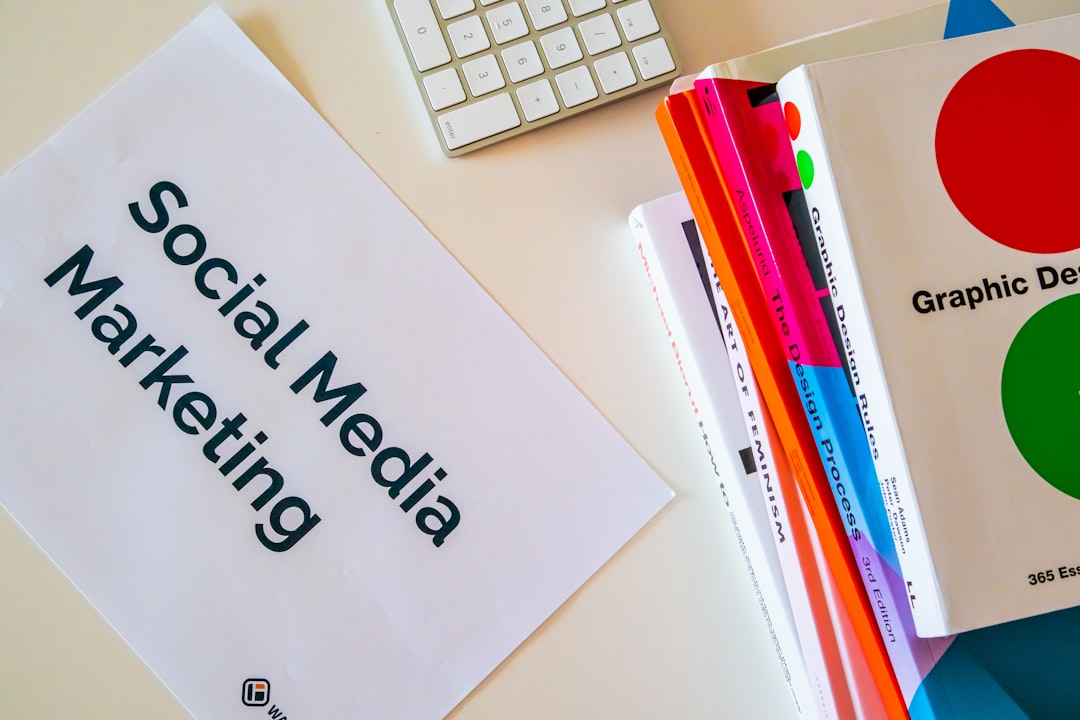 about-01 Home desk with design books and a paper with the words Social Media Marketing on it